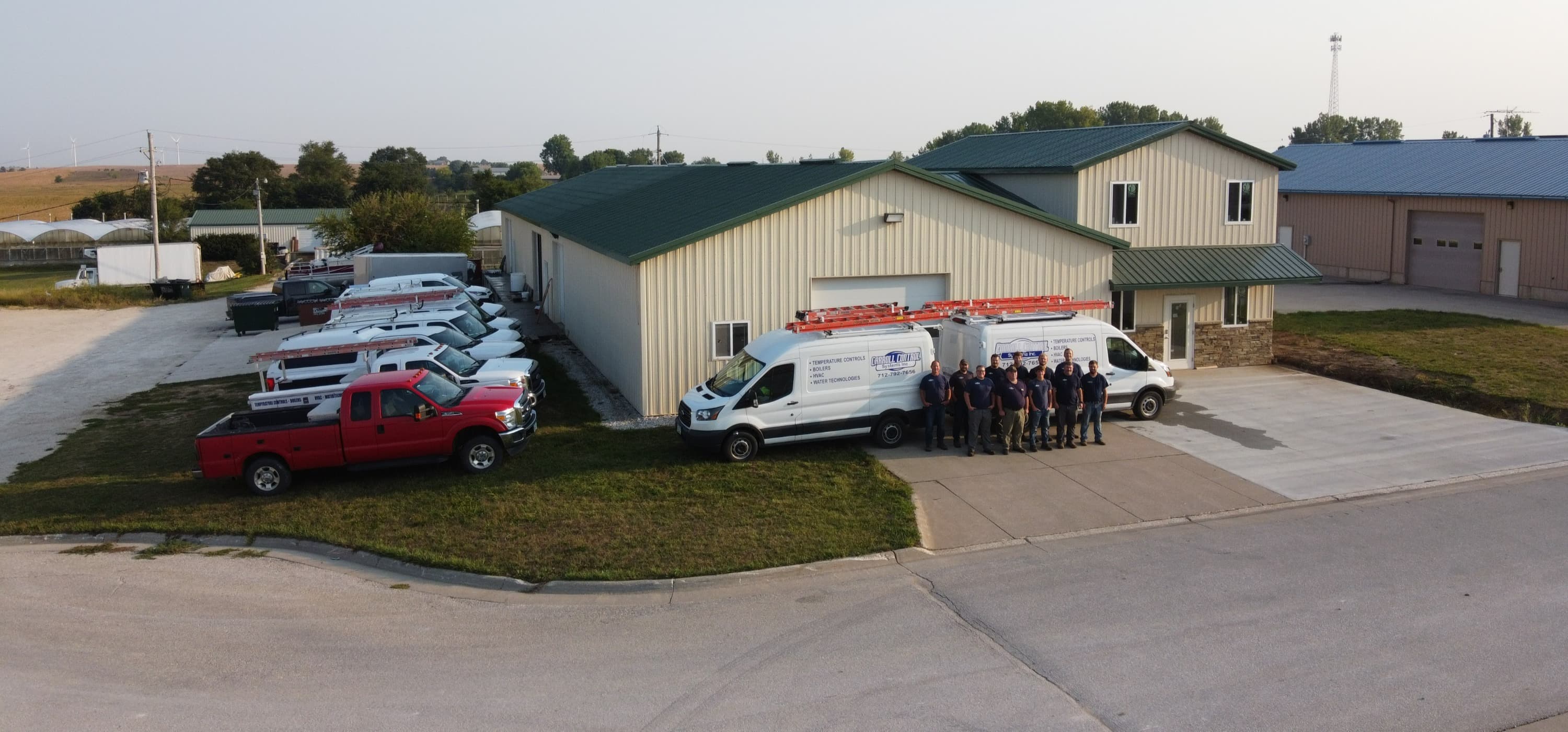 Carroll Control Systems headquarters — aerial view of building, fleet, and team